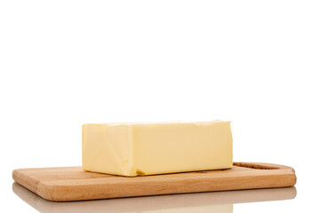 One piece of delicious butter on a wooden cutting board, close-up, isolated on a white background.