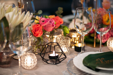 Wedding banquet. Table setting. Banquet tables are decorated with compositions of yellow flowers and protea, ranunculus on the tables are plates with napkins, glasses, candles and cutlery