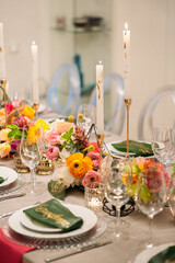 Wedding banquet. Table setting. Banquet tables are decorated with compositions of yellow flowers and protea, ranunculus on the tables are plates with napkins, glasses, candles and cutlery