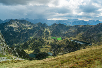 Naklejka premium Clouds over the mountains with beautiful lakes in the valley.