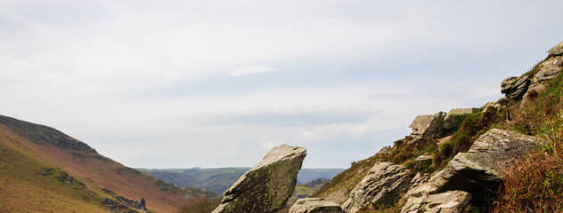 Fototapeta premium Massive rocks in the mountains. Wide panoramic view of the mountains. Lynmouth, Devon, England, UK