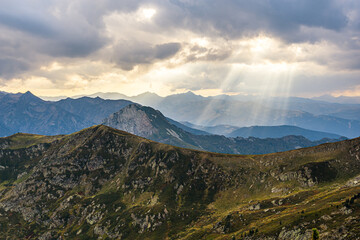 Obraz na płótnie Canvas Amazing rays of light passing trough the mountain clouds.
