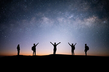 Silhouette small group of young traveler and backpacker watched the star and milky way on top of...