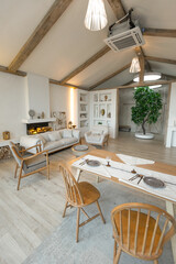 cozy warm home interior of a chic country house with an open plan, wood finishes, warm colors and a family hearth