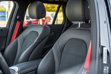 a car seat of a modern car with red accent