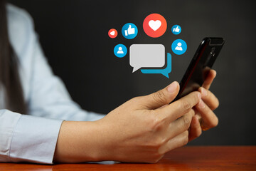 Social media and digital online concepts Woman using smartphone. Holiday living concept and social media play. Social Distancing concept. Work from home. on a dark background.