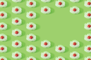 Pattern made with fresh fruit and plastic bubble wrap on green background. Creative copy space.
