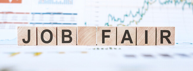 Job Fair phrase printed on wooden cubes on charts and diagrams white background.