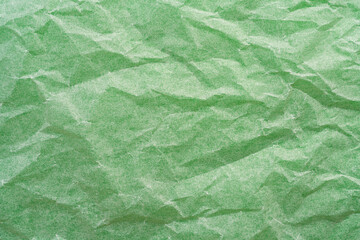 crumpled paper on a green surface