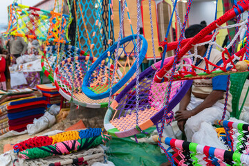 Haning chairs, hammocks and swings, handicraft products being sold at hastashilpomela or handicrafts fair at Kolkata, West Bengal, India
