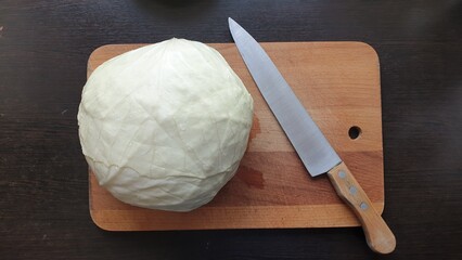 Knife and cabbage on the kitchen table