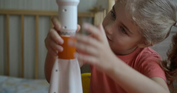 Creative Child Playing With Toy Space Rocket. Child Dreamer Playing With Toy Space Rocket. Little Kid Girl Building Mars Landing Mission Rocket. Education Science.