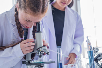 group children study science subjects and use Microscope