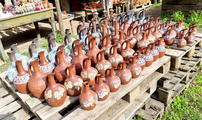 A counter with jugs and ceramic handicrafts made in  Georgian national style put up for sale