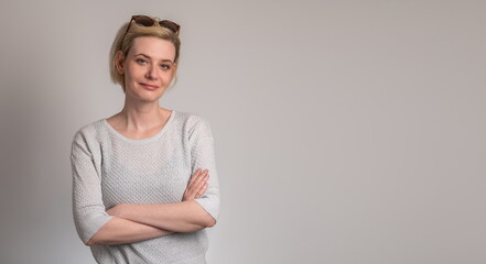 Portrait of charming attractive blonde girl cross hands with sunglasses on head ready decide choose choice decisions solution wear stylish clothes over gray color background