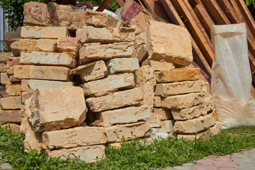 construction waste from bricks,pile of old bricks in the yard, dismantling the old wall