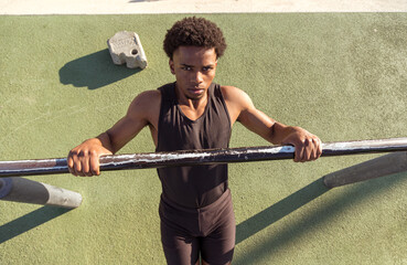 Calisthenics exercises. Sporty guy. Outdoor training and working out.