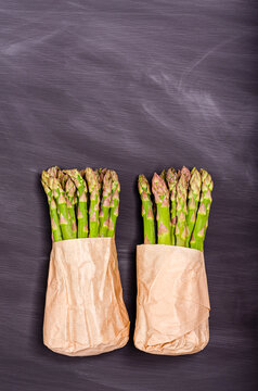 Green fresh asparagus on a black background with place for text.