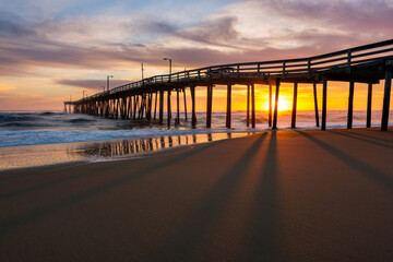 Fototapeta na wymiar Sunrise behind fishing pier along North Carolina's Outer Banks