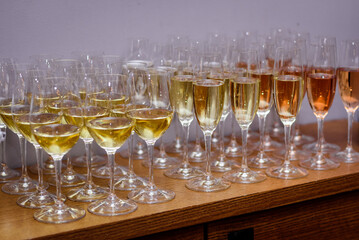 Rows of glasses with alcohol on degustation 