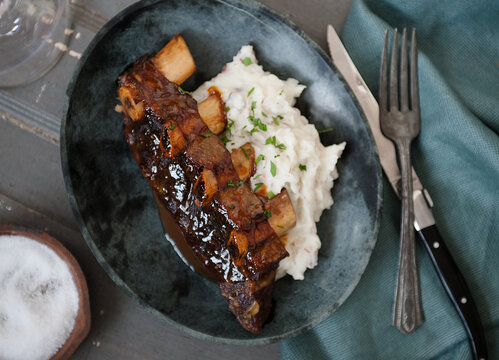 Braised Ribs with Mashed Potatoes; Fork Piercing the Meat