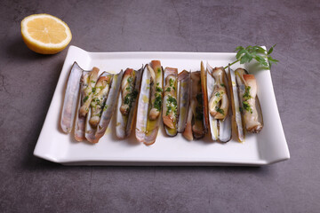 Grilled razor clams from the estuary with olive oil, garlic and parsley.