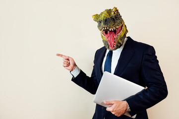 Euphoric man with lizard head with laptop