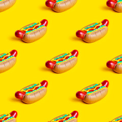 Toy American rubber hot dog repeat seamless pattern on bright yellow background.