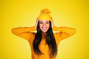 Happy young woman in a bright yellow clothes
