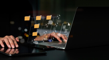 IT consultant installing Document Management System (DMS) on laptop computer with document...