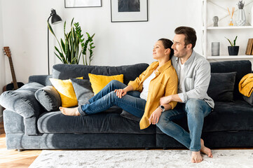 Concept of support and caring in marriage. Gentle and lovely mid-aged couple in love sitting in...