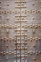 old rusty iron doors with rivets ancient architecture