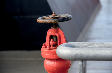 Close up image of red water pipe walve.