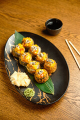 A set of sushi rolls with salmon, caviar, avocado and black sesame