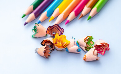 pencil shaving flowers and sharp pencils, different colors, chaotic arrangement, ready for art shop, creative, waste from sharpening. funny activities for kids, kindergarten.