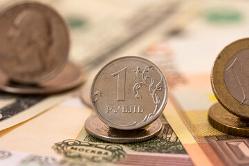 Russian ruble coin, dollar and euro coins, banknotes. Confrontation of Russian Ruble and dollar, euro