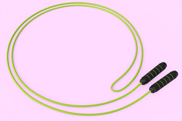 Green skipping rope or jumping rope isolated on pink background.