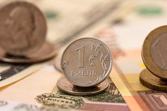 Russian ruble coin, dollar and euro coins, banknotes. Confrontation of Russian Ruble and dollar, euro