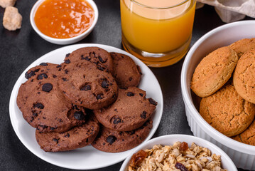 Delicious nutritious healthy breakfast with granola, eggs, oat cookies, milk and jam