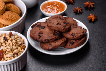 Delicious nutritious healthy breakfast with granola, eggs, oat cookies, milk and jam