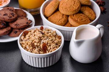 Delicious nutritious healthy breakfast with granola, eggs, oat cookies, milk and jam