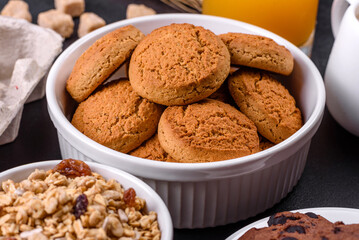 Delicious nutritious healthy breakfast with granola, eggs, oat cookies, milk and jam