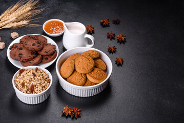 Delicious nutritious healthy breakfast with granola, eggs, oat cookies, milk and jam