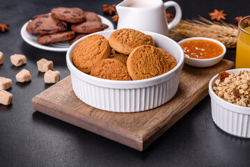 Delicious nutritious healthy breakfast with granola, eggs, oat cookies, milk and jam