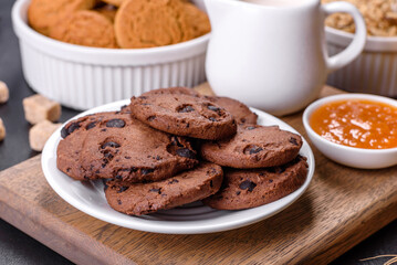 Delicious nutritious healthy breakfast with granola, eggs, oat cookies, milk and jam
