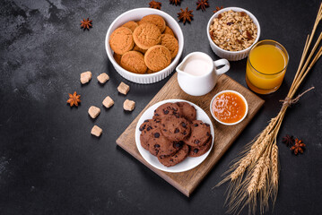 Delicious nutritious healthy breakfast with granola, eggs, oat cookies, milk and jam