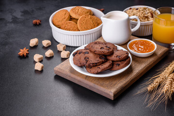 Delicious nutritious healthy breakfast with granola, eggs, oat cookies, milk and jam