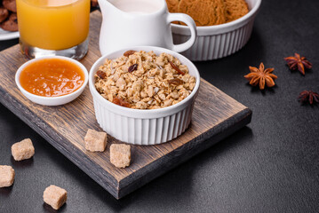 Delicious nutritious healthy breakfast with granola, eggs, oat cookies, milk and jam