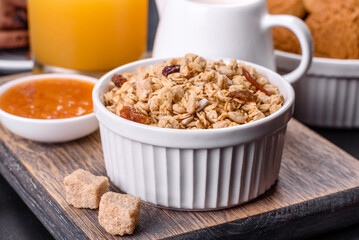 Delicious nutritious healthy breakfast with granola, eggs, oat cookies, milk and jam