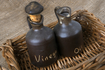 close up of the olive oil and vinegar bottles on hessian
